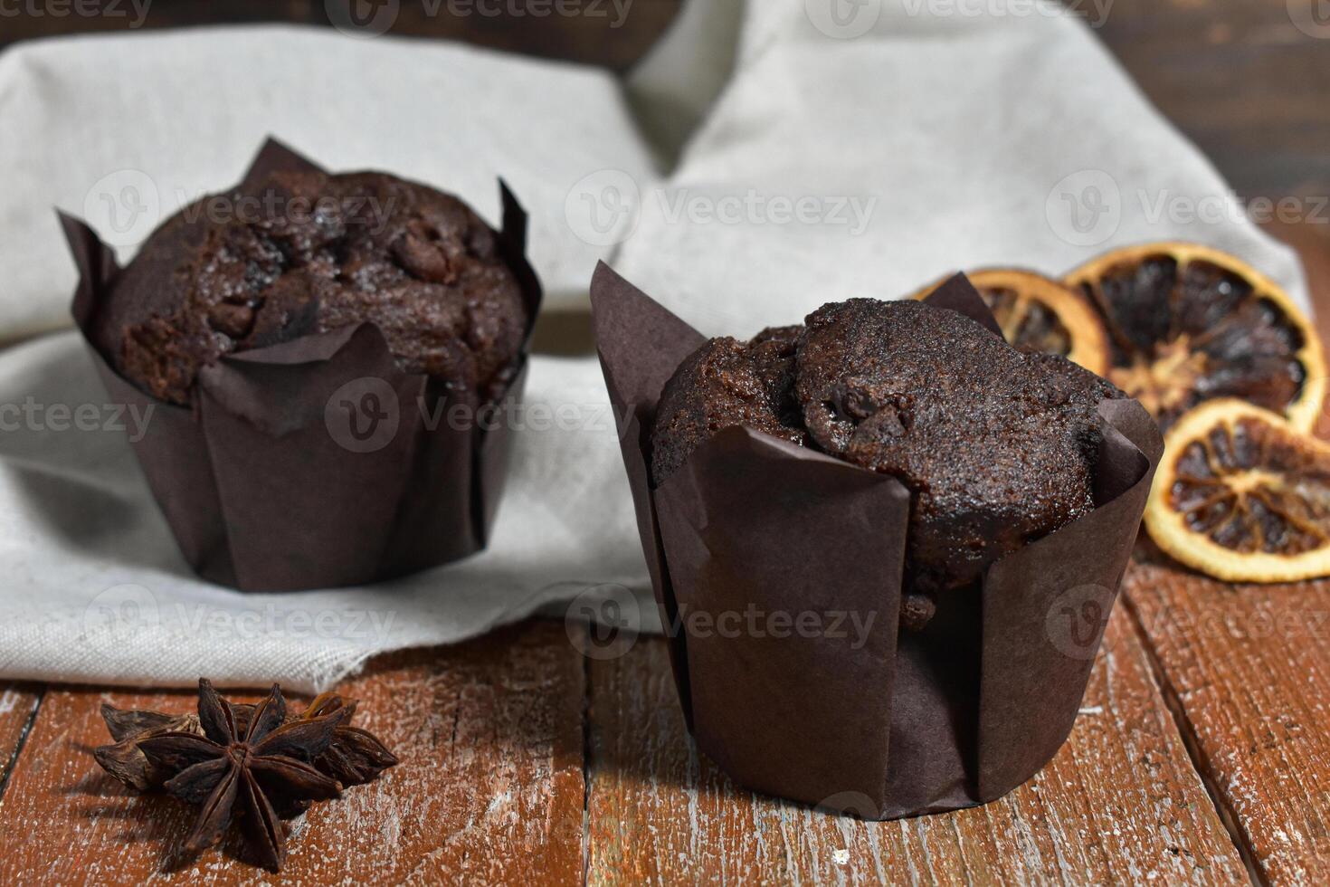 Chocolate muffins on wood background photo