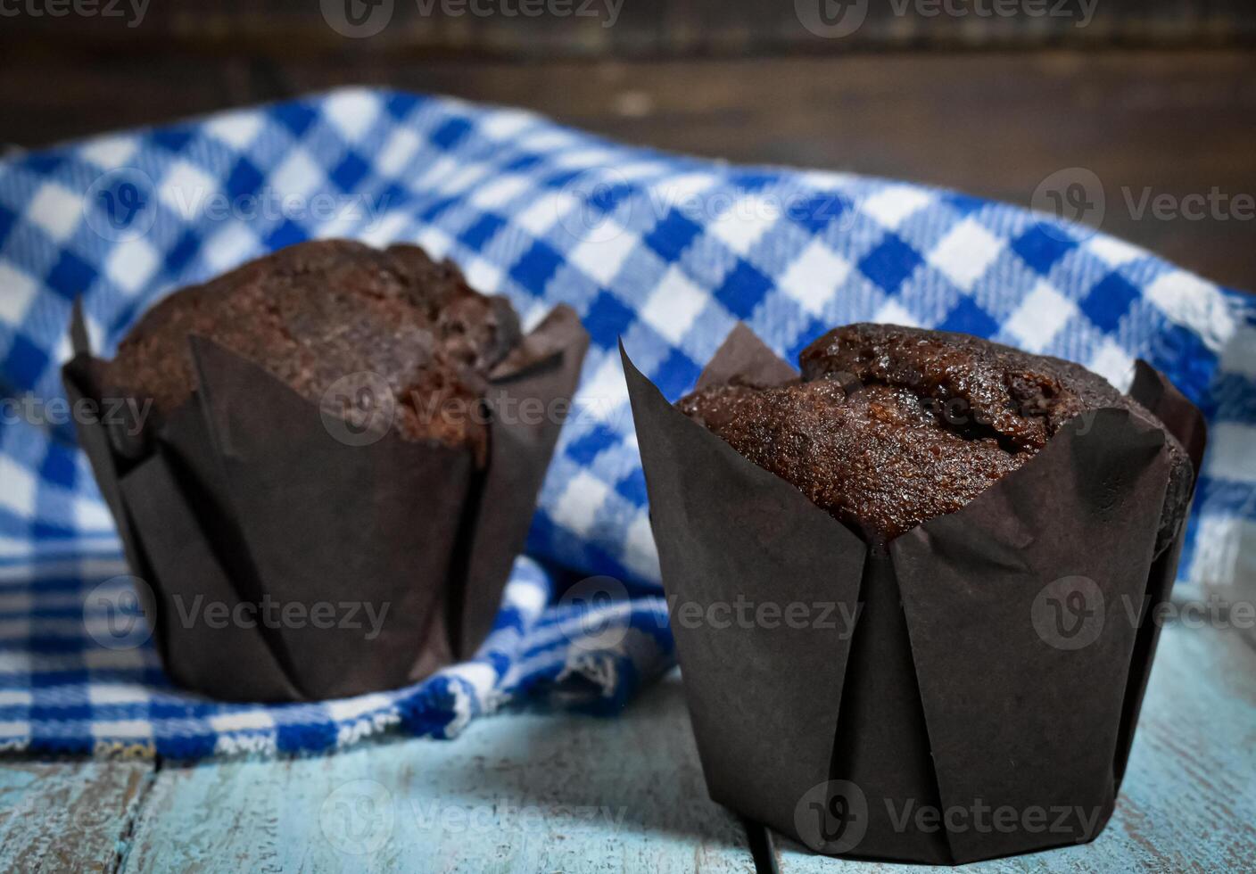 Chocolate muffins on wood background photo