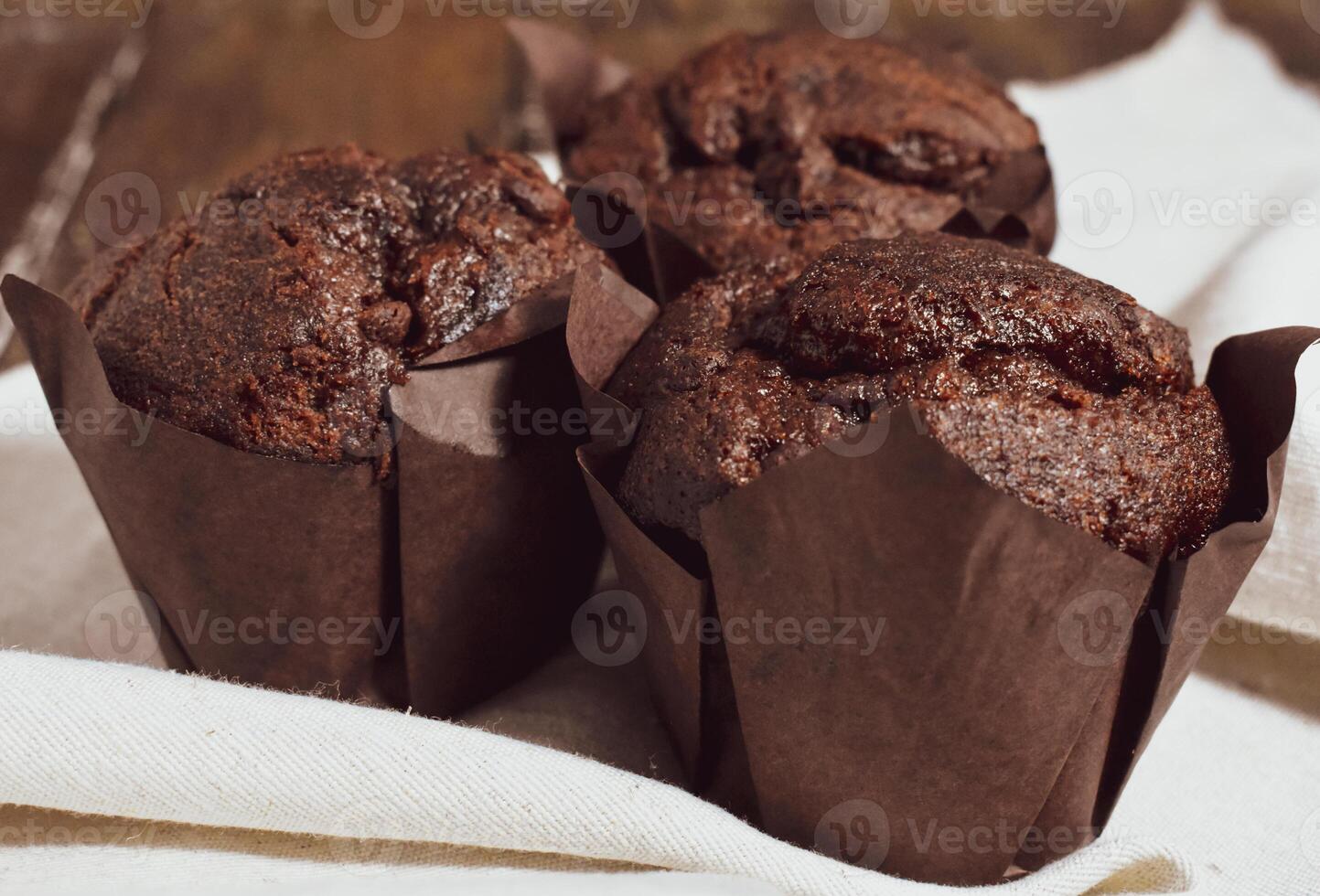 Chocolate muffins on wood background photo