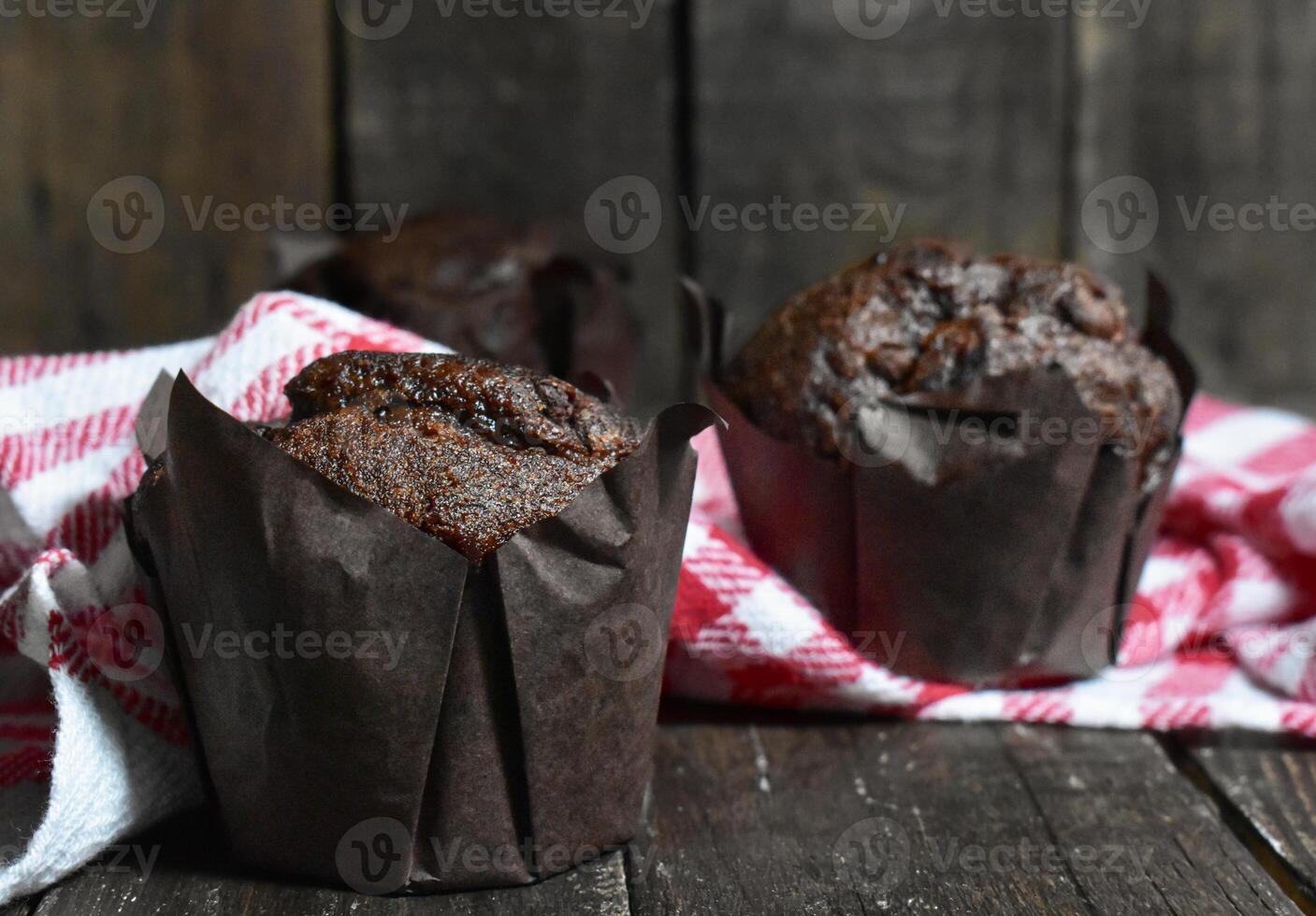 Chocolate muffins on wood background photo