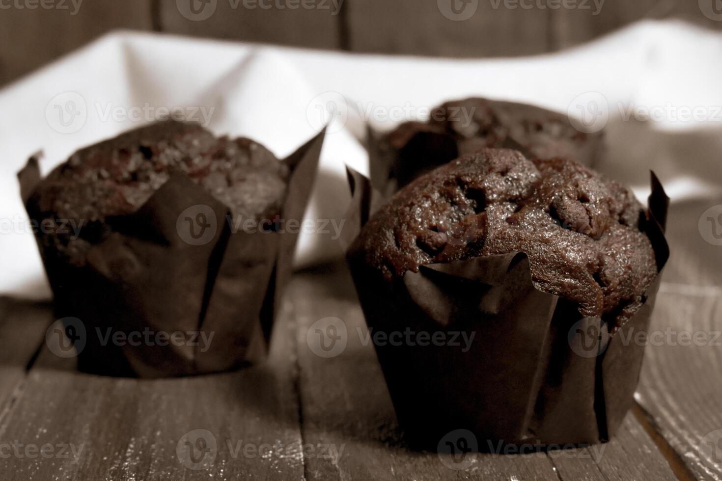 Chocolate muffins on wood background photo