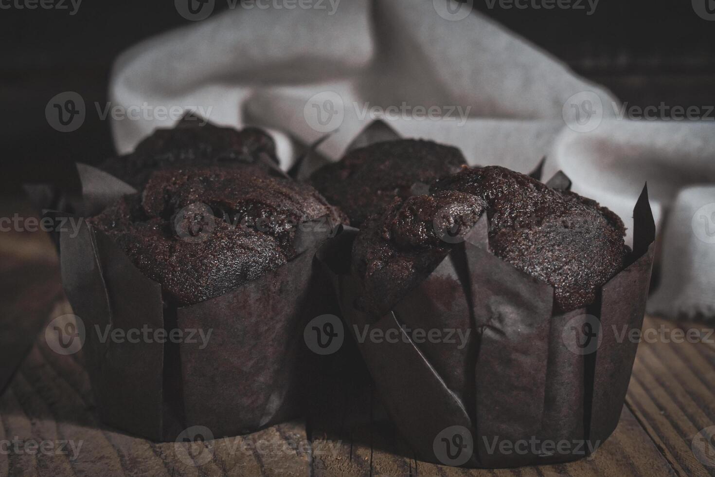 Chocolate muffins on wood background photo