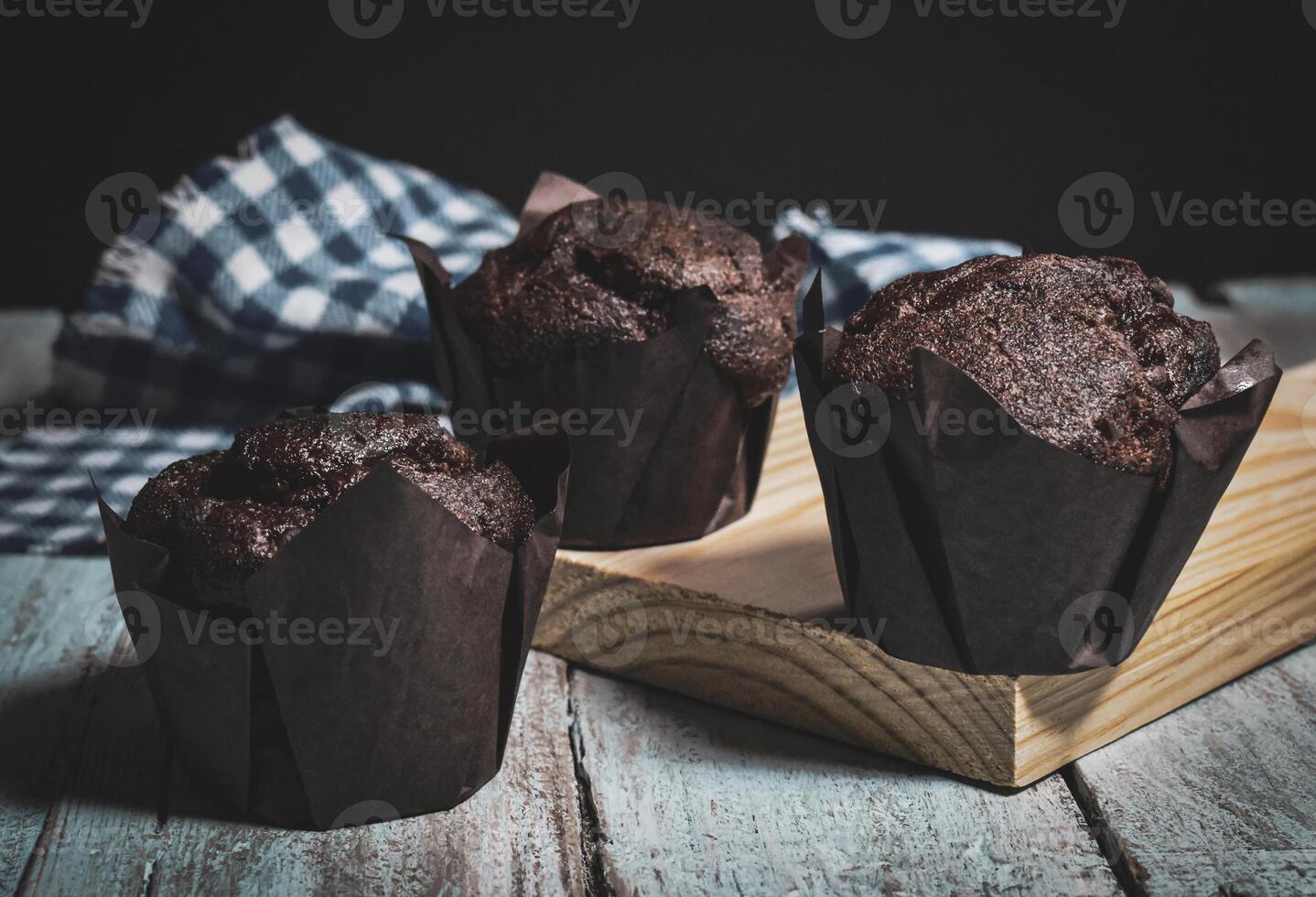 Chocolate muffins on wood background photo