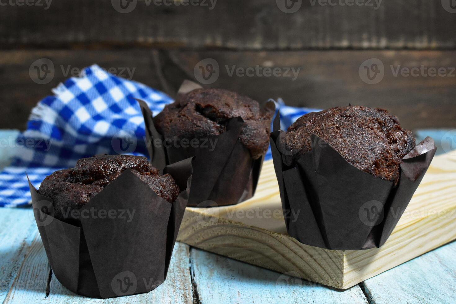 Chocolate muffins on wood background photo