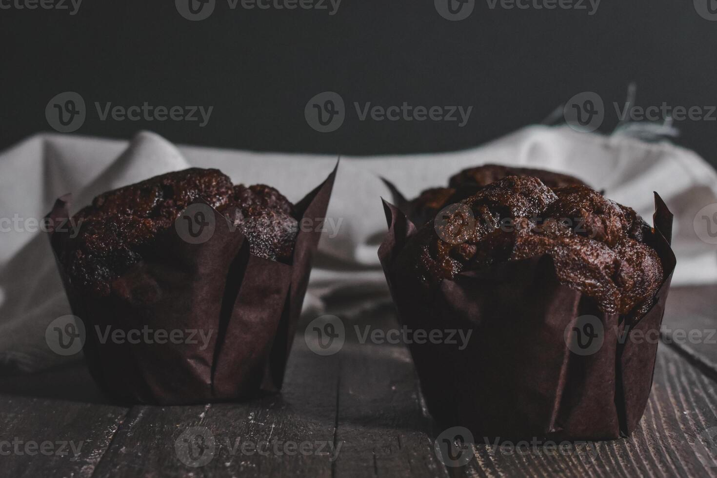 Chocolate muffins on wood background photo