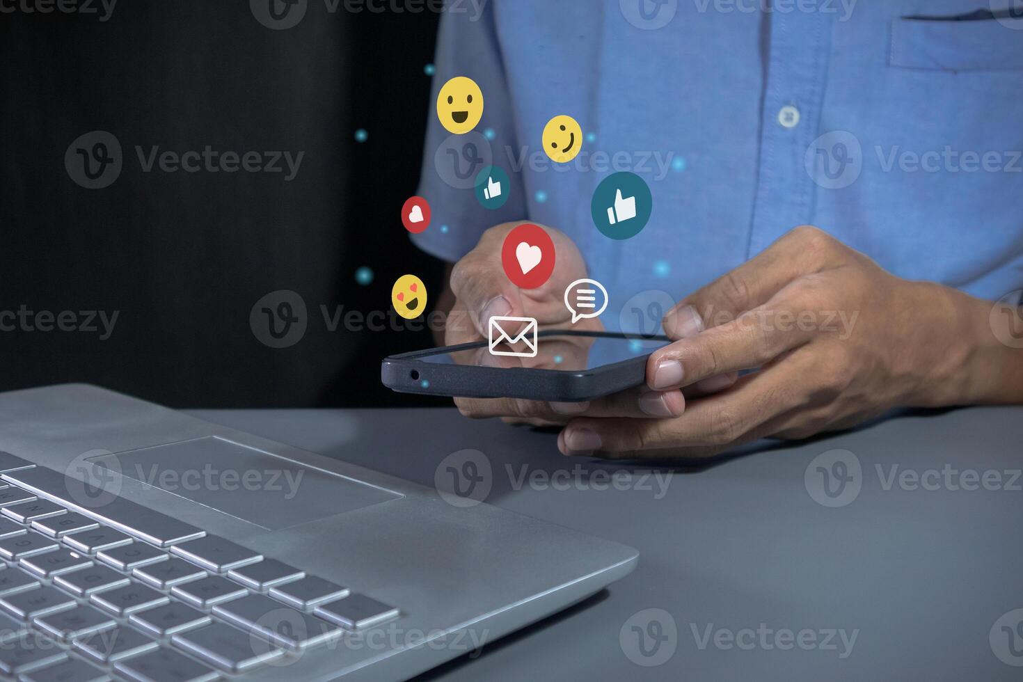 Man holding a smartphone to open social media applications. Chat with friends and send emotion icons. photo