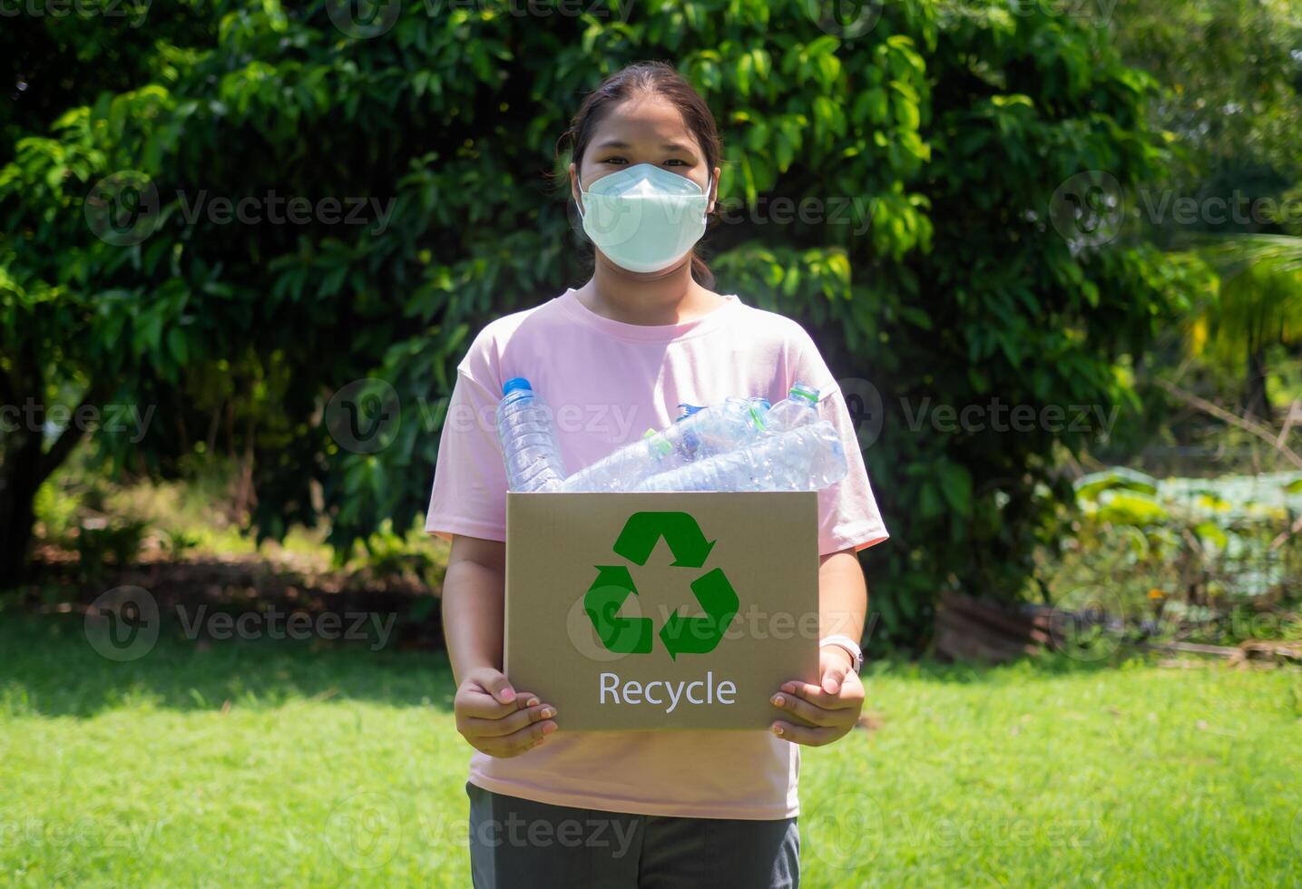 Reduction environmental pollution and recycle concept, woman collecting garbage and holding a recycle bin with plastic bottles in the outdoors, Plastic-free, Junk food plastic packaging. photo