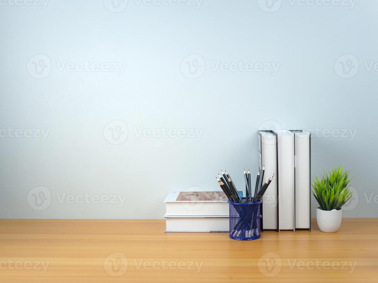 Back to school concept, Book stack and Pencil on wooden table workspace area and white wall, Concept of time to study, Read books, Concept of preparing for exams. photo