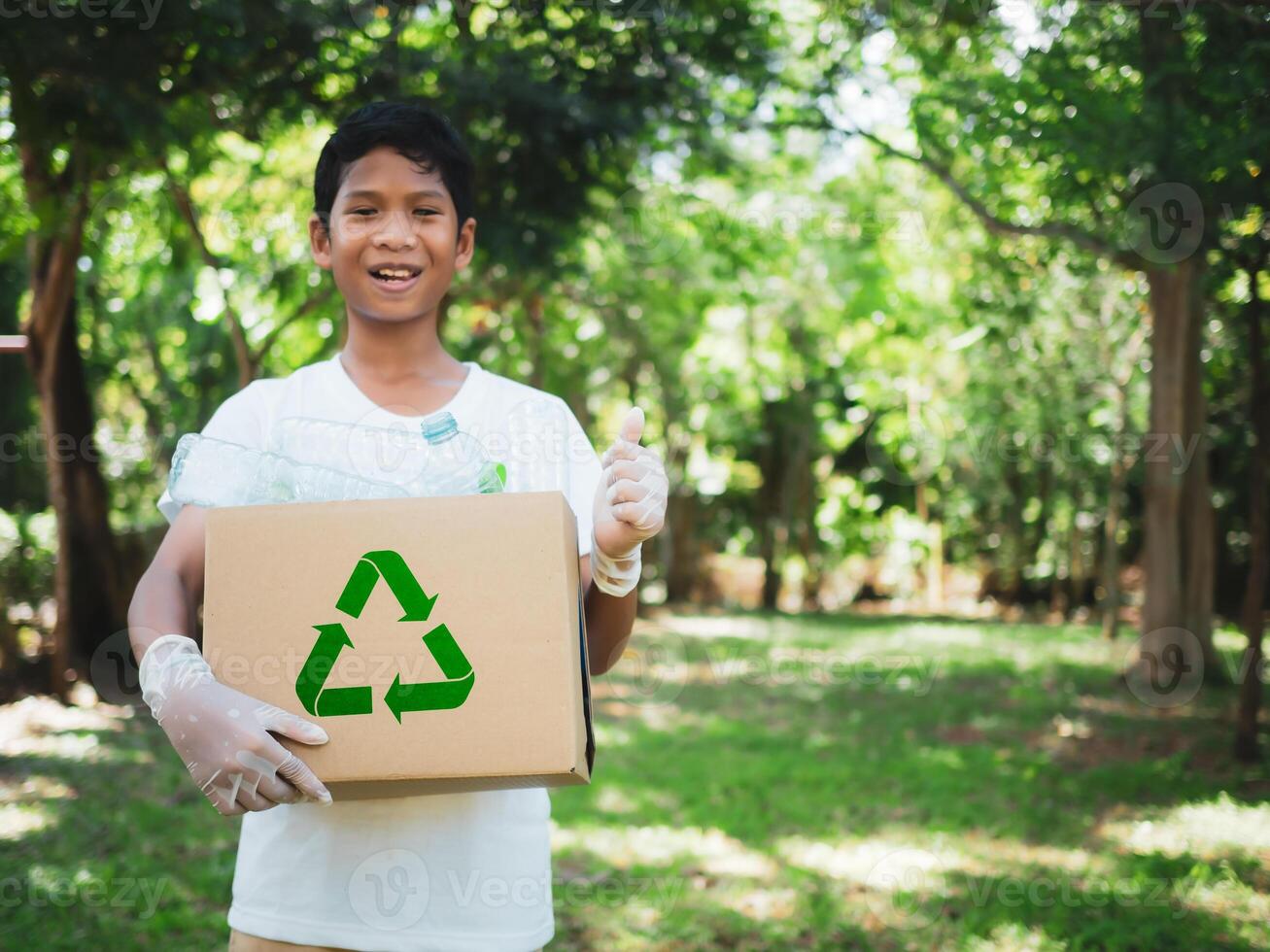 Boy hold cardboard boxes for recycling and holding a recycle bin with plastic bottles in the outdoors, Reduction environmental pollution and recycle concept, Plastic-free, Junk food plastic packaging. photo