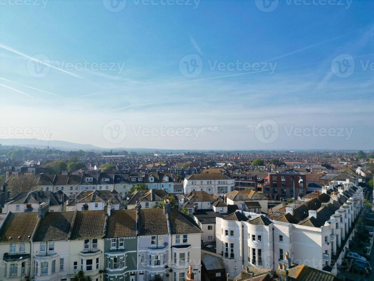 High Angle View of Historical Central Eastbourne Buildings and City of England, United Kingdom. Aerial Footage Was Captured with Drone's Camera During Windy Day on May 11th, 2024 photo