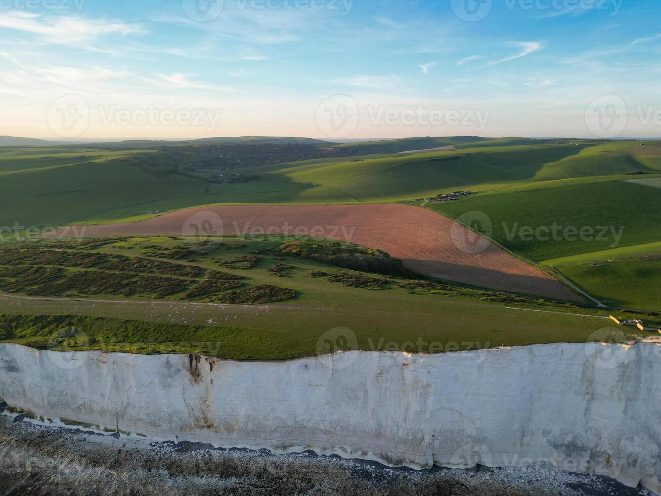 High Angle View of British Tourist Attraction of United Kingdom at Beachy Head headland Sea View and Ocean at Eastbourne, East Sussex, England. Drone's Camera Footage Was Captured on May 10th, 2024 photo