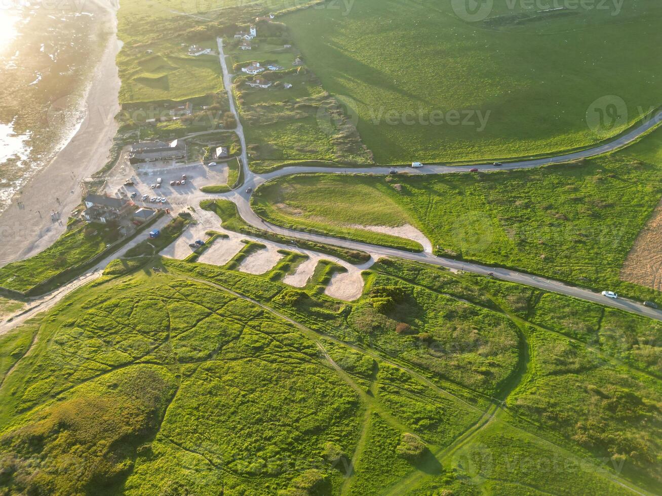 High Angle View of British Tourist Attraction of United Kingdom at Beachy Head headland Sea View and Ocean at Eastbourne, East Sussex, England. Drone's Camera Footage Was Captured on May 10th, 2024 photo