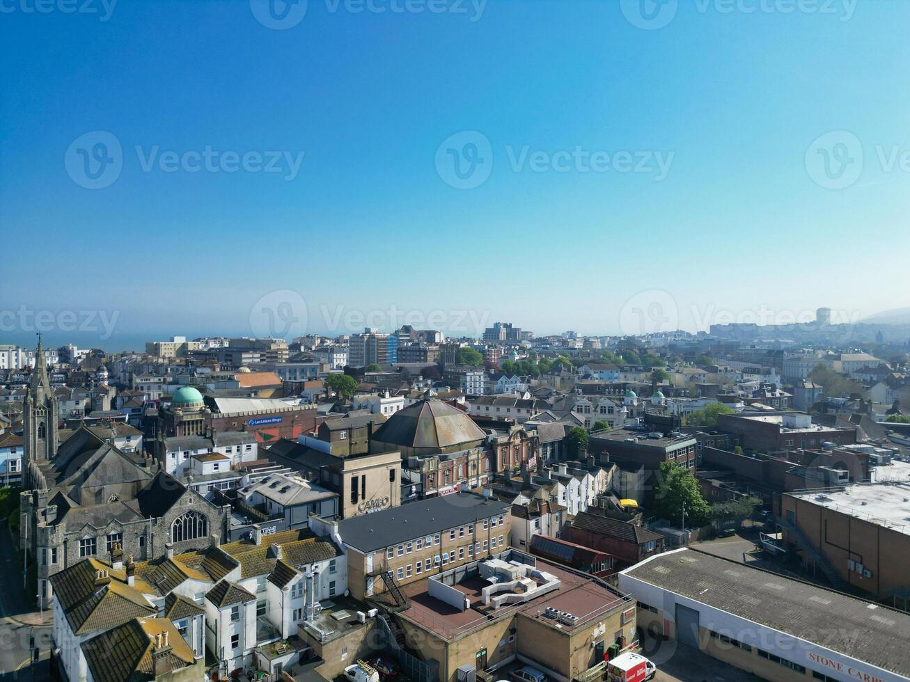High Angle View of Historical Central Eastbourne Buildings and City of England, United Kingdom. Aerial Footage Was Captured with Drone's Camera During Windy Day on May 11th, 2024 photo