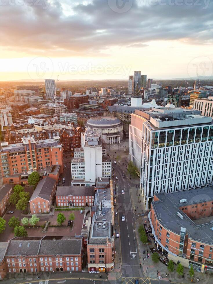 Aerial View of Greater Manchester City Centre and Tall Buildings During Golden Hour of Sunset. England UK. High Angle Footage Was Captured with Drone's Camera During Windy day of May 5th, 2024 photo