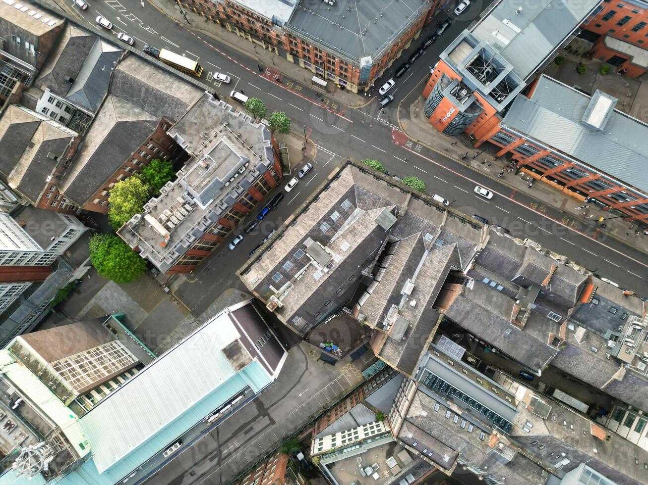 Aerial View of Greater Manchester City Centre and Tall Buildings During Golden Hour of Sunset. England UK. High Angle Footage Was Captured with Drone's Camera During Windy day of May 5th, 2024 photo
