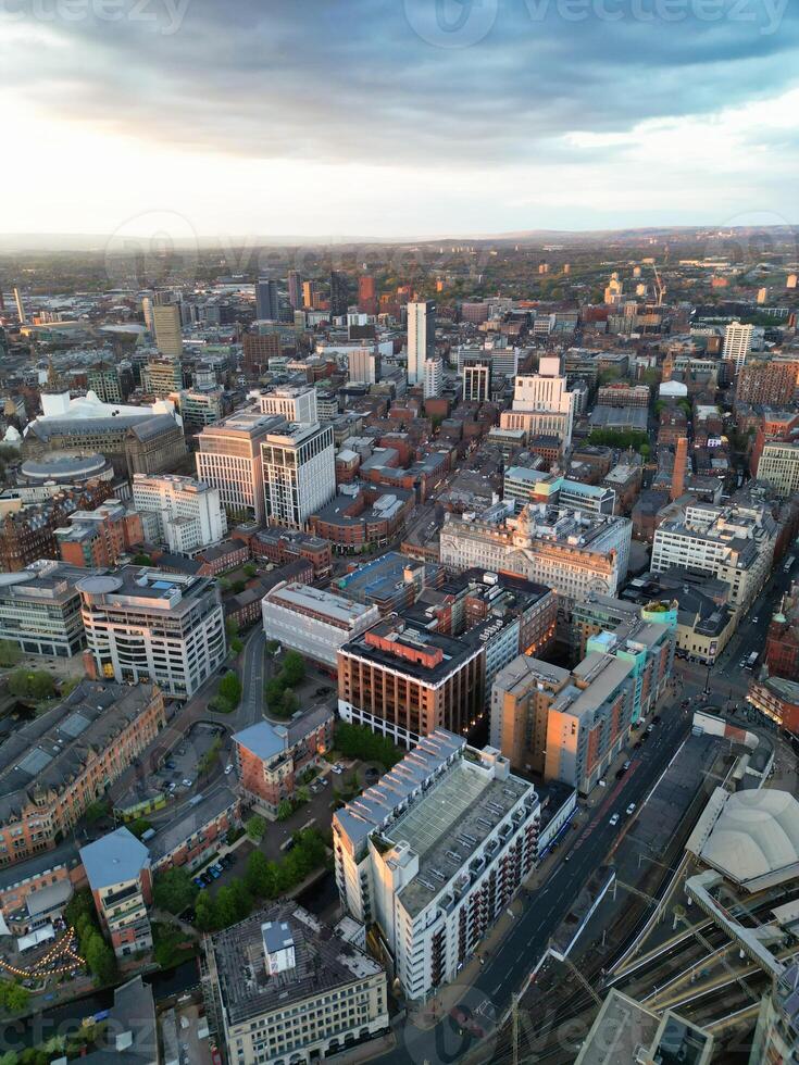 Aerial View of Greater Manchester City Centre and Tall Buildings During Golden Hour of Sunset. England UK. High Angle Footage Was Captured with Drone's Camera During Windy day of May 5th, 2024 photo