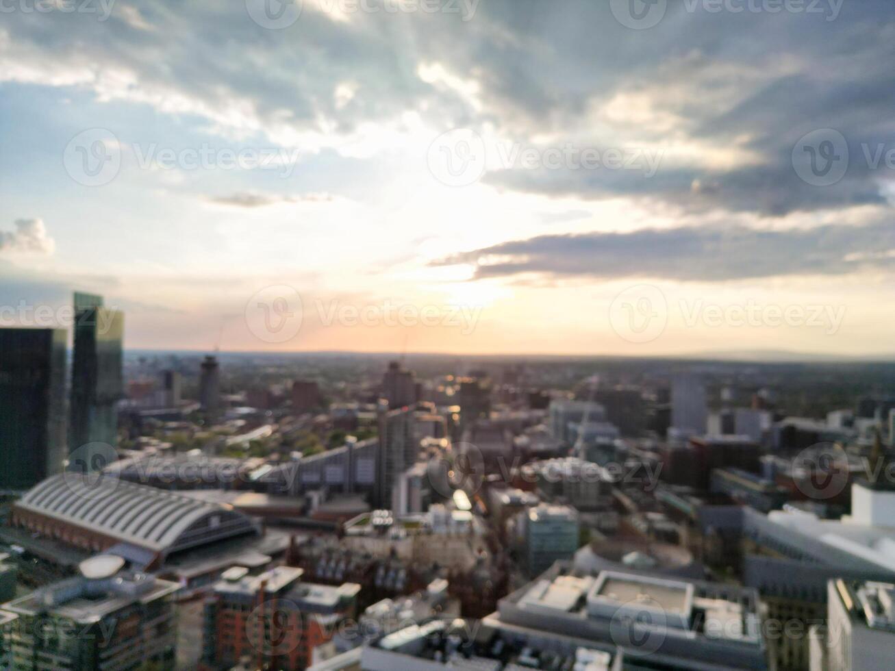 Aerial View of Greater Manchester City Centre and Tall Buildings During Golden Hour of Sunset. England UK. High Angle Footage Was Captured with Drone's Camera During Windy day of May 5th, 2024 photo