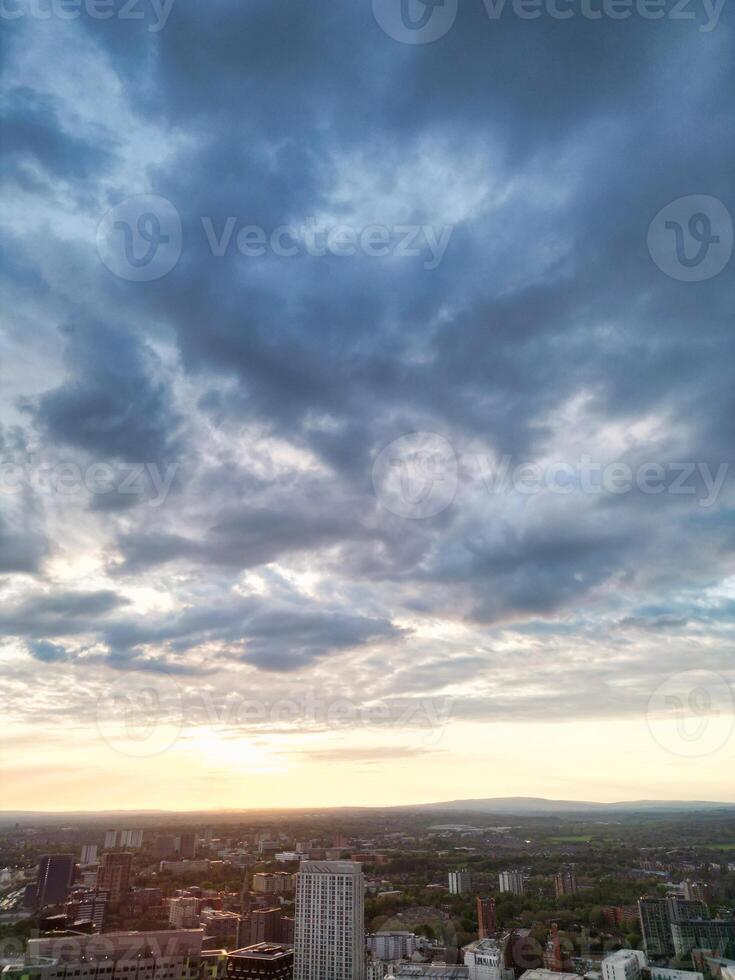 Aerial View of Greater Manchester City Centre and Tall Buildings During Golden Hour of Sunset. England UK. High Angle Footage Was Captured with Drone's Camera During Windy day of May 5th, 2024 photo