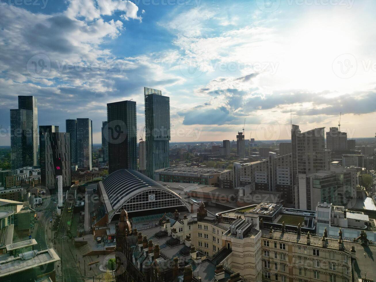 Aerial View of Greater Manchester City Centre and Tall Buildings During Golden Hour of Sunset. England UK. May 5th, 2024, High Angle Footage Was Captured with Drone's Camera photo