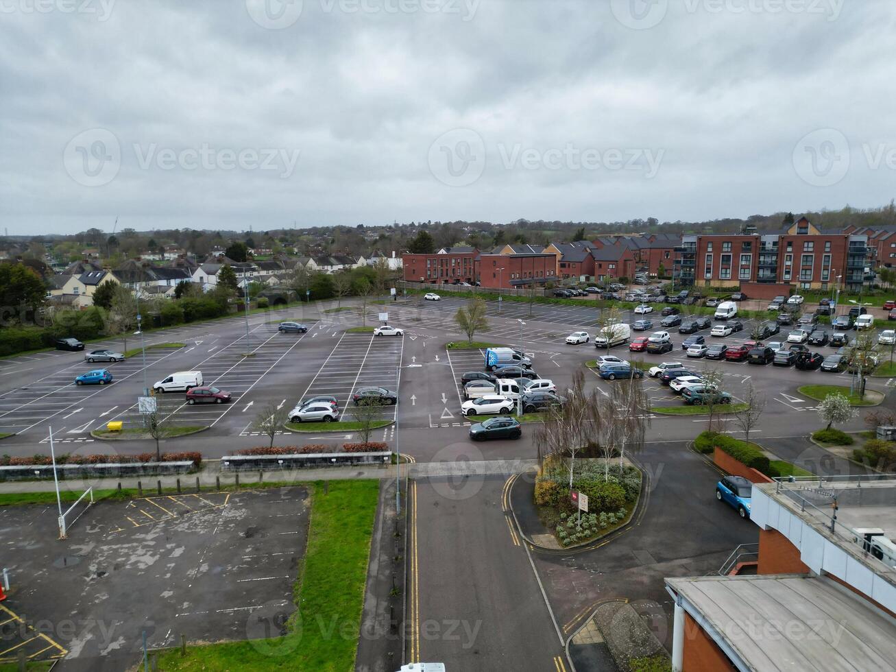 high Angle View of Buildings at Central Borehamwood London City of England United Kingdom. April 4th, 2024, Aerial View Was Captured with Drone's Camera From High altitude During Cloudy and Windy Day. photo