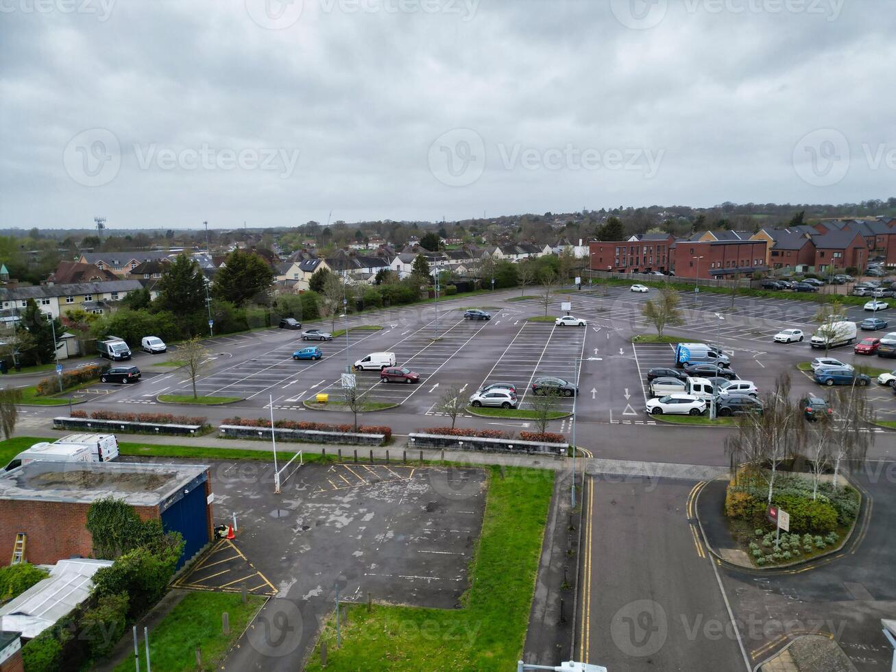 high Angle View of Buildings at Central Borehamwood London City of England United Kingdom. April 4th, 2024, Aerial View Was Captured with Drone's Camera From High altitude During Cloudy and Windy Day. photo