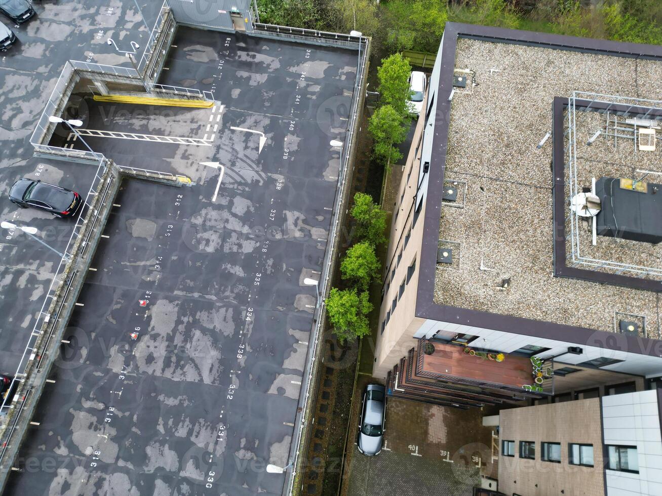 high Angle View of Buildings at Central Borehamwood London City of England United Kingdom. April 4th, 2024, Aerial View Was Captured with Drone's Camera From High altitude During Cloudy and Windy Day. photo