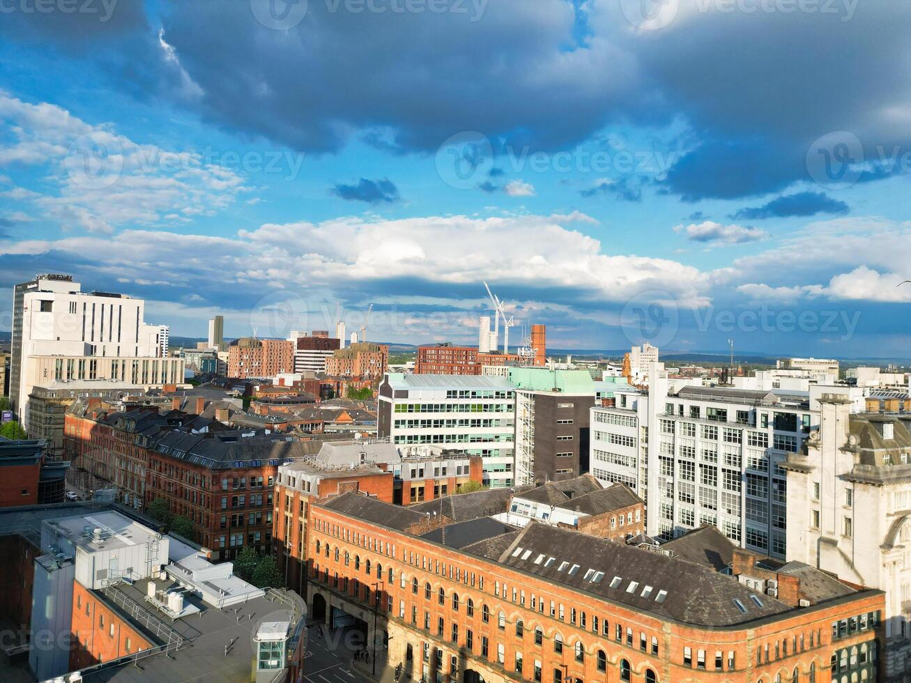 Aerial View of Greater Manchester City Centre and Tall Buildings During Golden Hour of Sunset. England UK. May 5th, 2024, High Angle Footage Was Captured with Drone's Camera photo