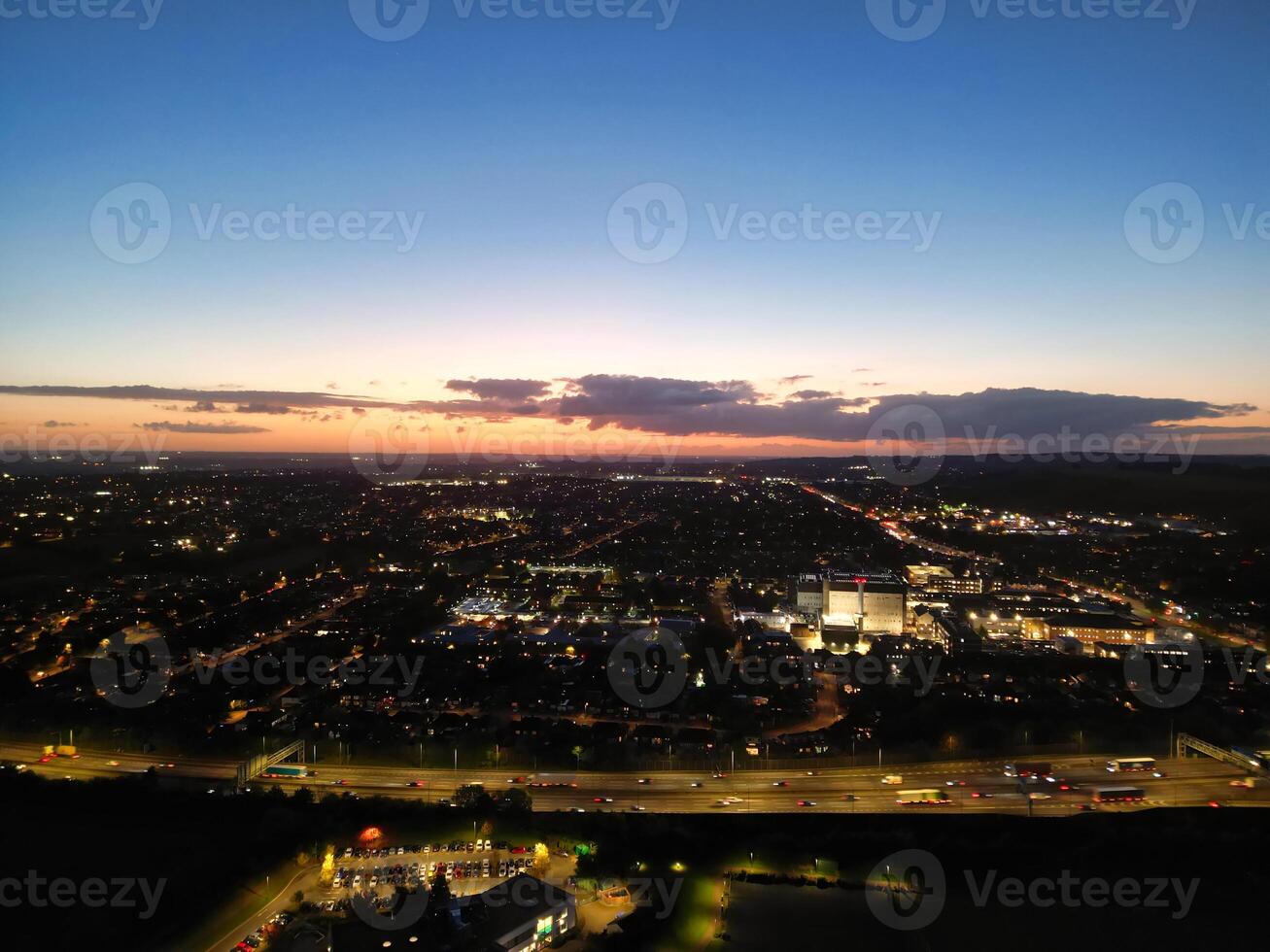 Most Beautiful High Angle View of Illuminated Luton City of England UK at Just After Sunset and Full Moon Night. Aerial Footage Was Captured with Drone's Camera on October 17th, 2024 photo
