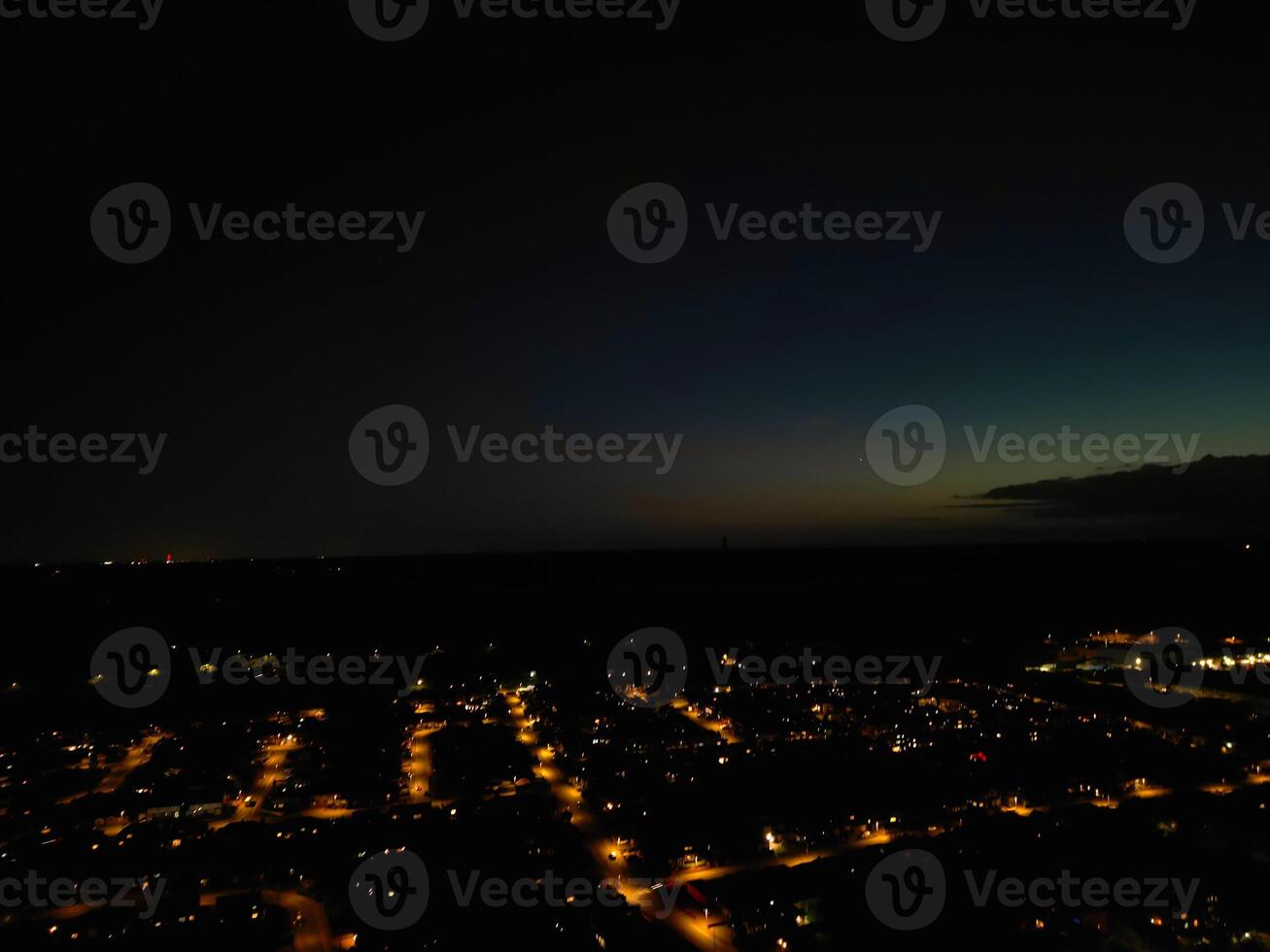 Most Beautiful High Angle View of Illuminated Luton City of England UK at Just After Sunset and Full Moon Night. Aerial Footage Was Captured with Drone's Camera on October 17th, 2024 photo
