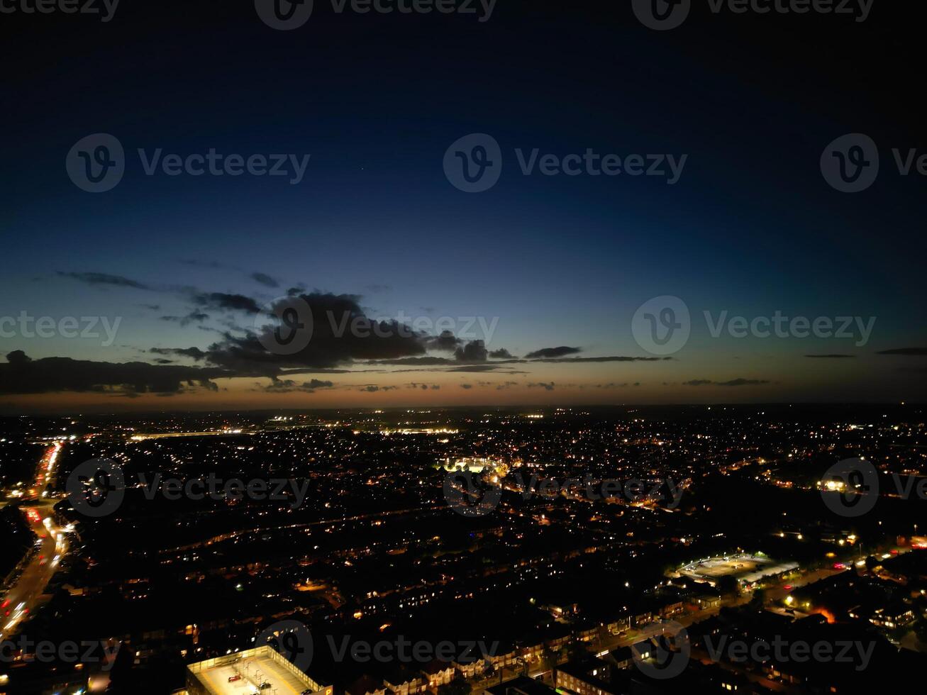 Most Beautiful High Angle View of Illuminated Luton City of England UK at Just After Sunset and Full Moon Night. Aerial Footage Was Captured with Drone's Camera on October 17th, 2024 photo