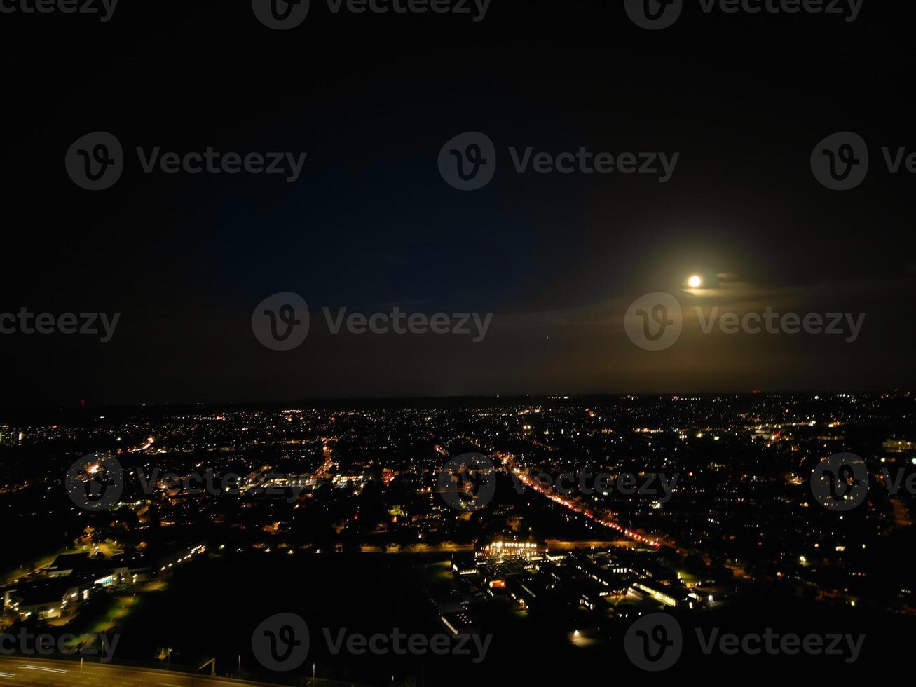 Most Beautiful High Angle View of Illuminated Luton City of England UK at Just After Sunset and Full Moon Night. Aerial Footage Was Captured with Drone's Camera on October 17th, 2024 photo