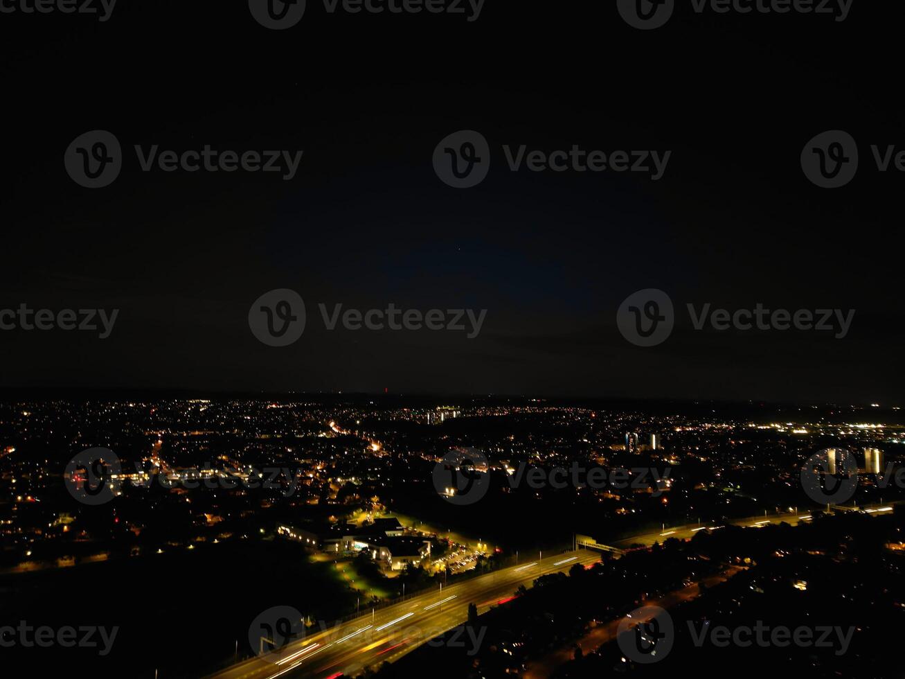 Most Beautiful High Angle View of Illuminated Luton City of England UK at Just After Sunset and Full Moon Night. Aerial Footage Was Captured with Drone's Camera on October 17th, 2024 photo