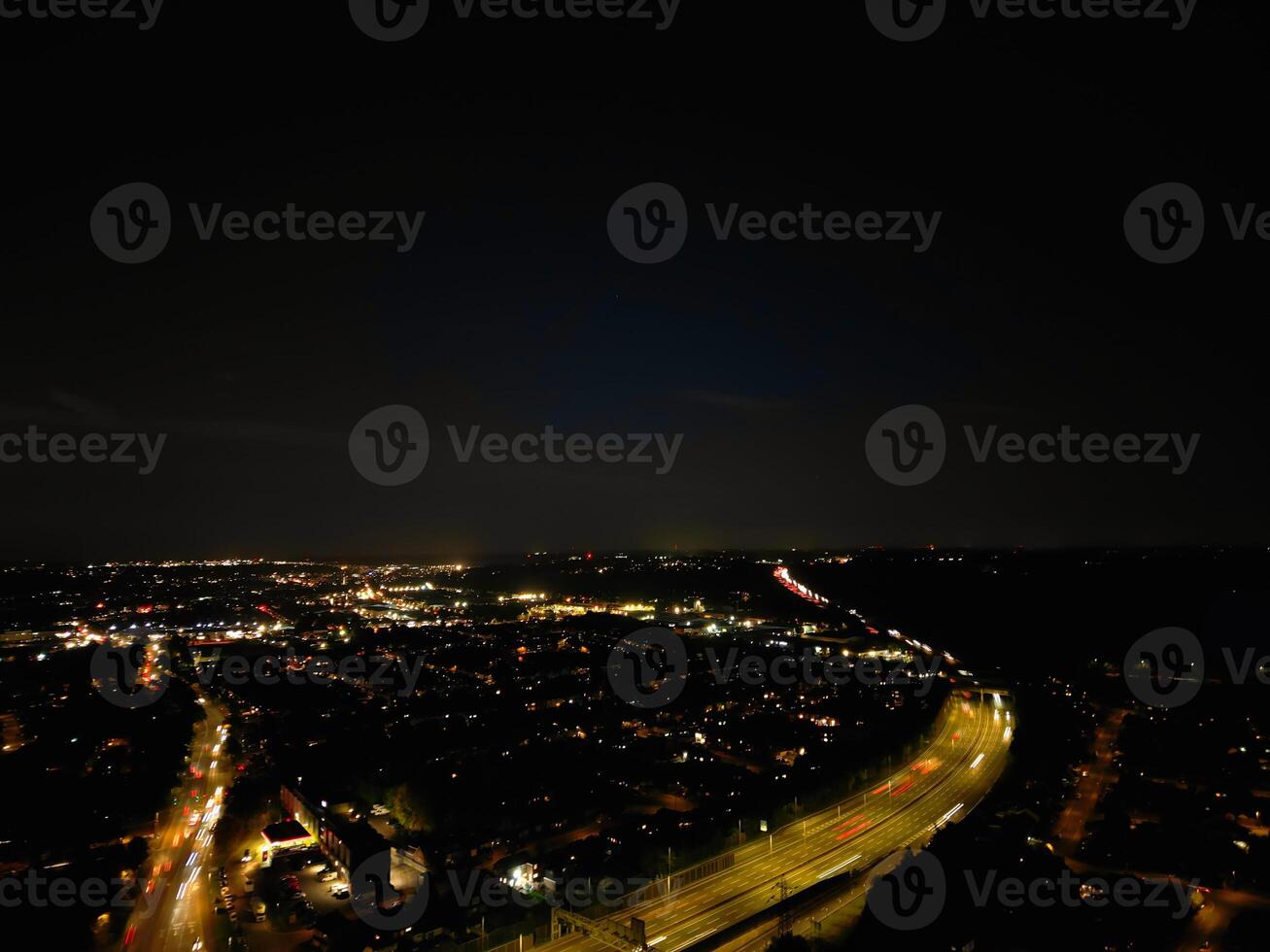 Most Beautiful High Angle View of Illuminated Luton City of England UK at Just After Sunset and Full Moon Night. Aerial Footage Was Captured with Drone's Camera on October 17th, 2024 photo