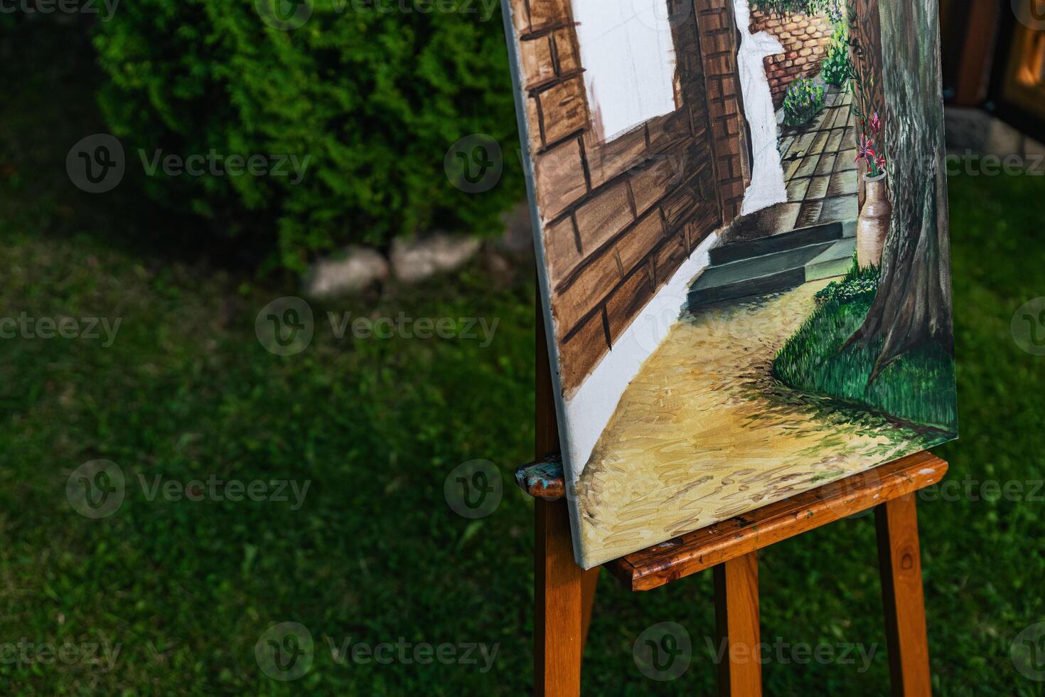 Close-up of someone skillfully painting on a canvas. The artwork looks like it depicts a rustic scene, possibly featuring elements like bricks or wood, giving it a cozy, homely feel. photo