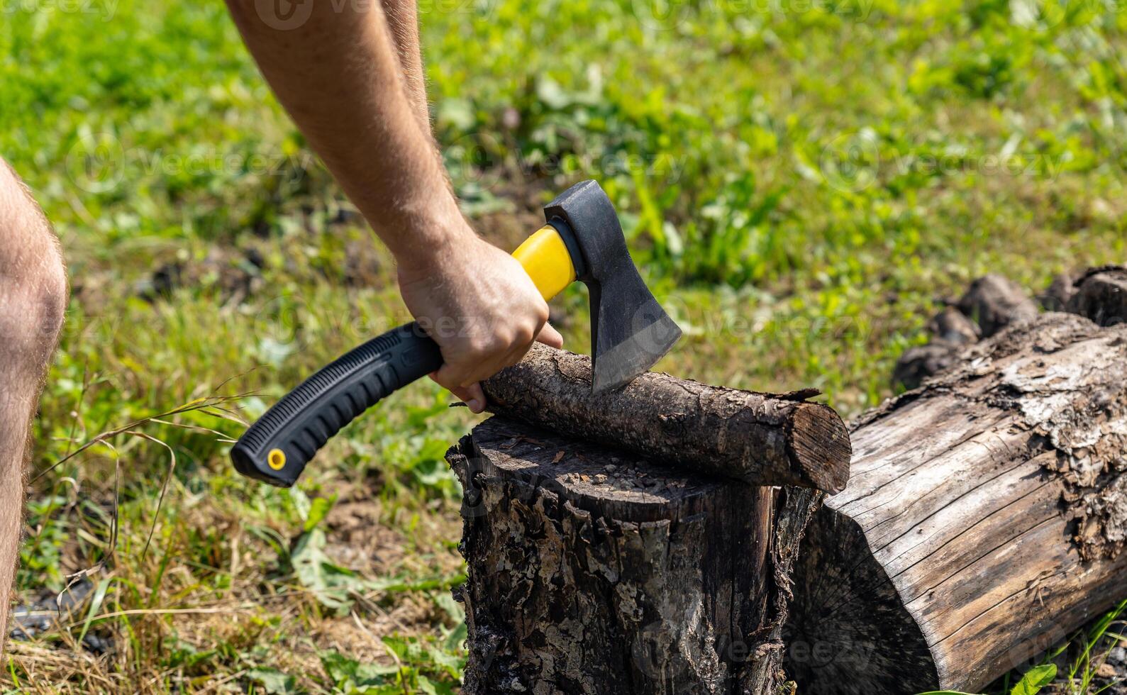 Steel axe, metal ax for wood chopping. Man holding heavy ax. Axe in lumberjack hands chopping or cutting wood trunks. photo