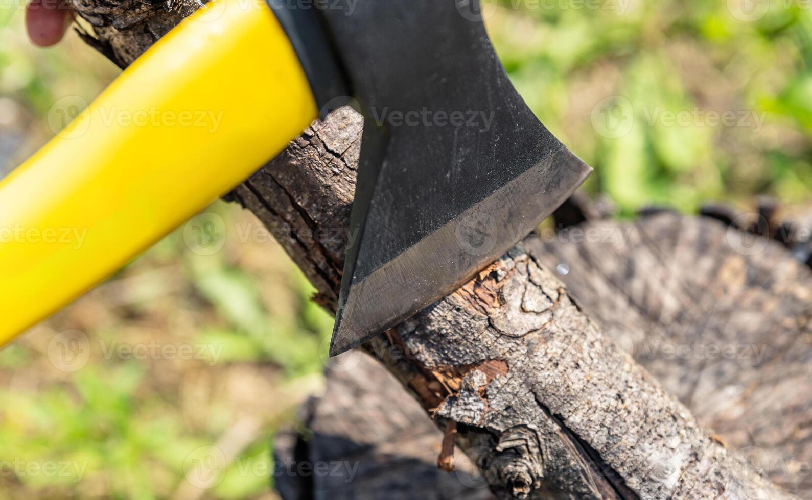 Steel axe, metal ax for wood chopping. Man holding heavy ax. Axe in lumberjack hands chopping or cutting wood trunks. photo
