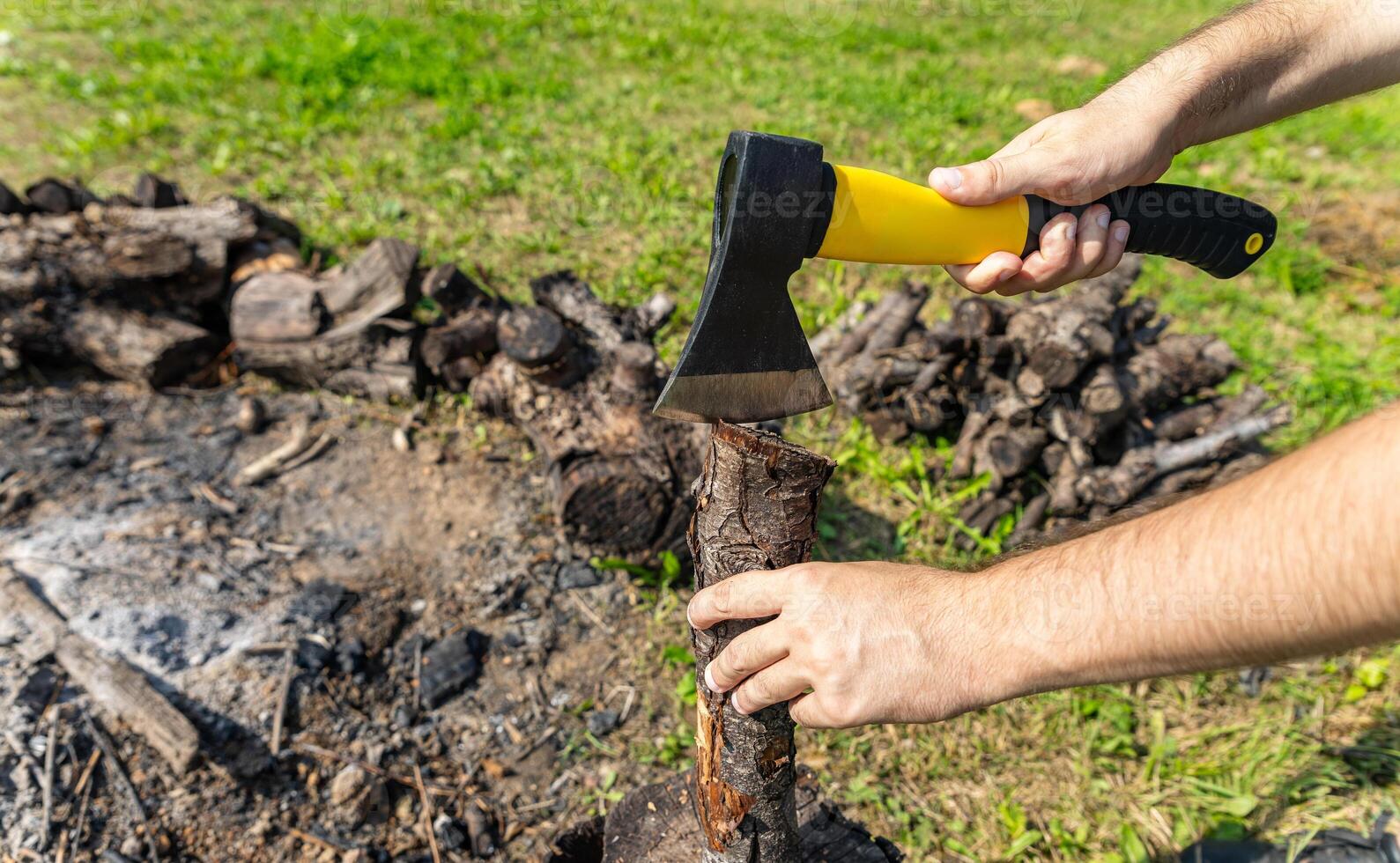 Steel axe, metal ax for wood chopping. Man holding heavy ax. Axe in lumberjack hands chopping or cutting wood trunks. photo