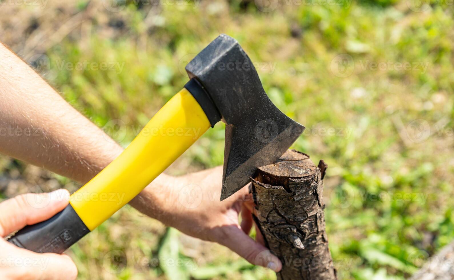 Steel axe, metal ax for wood chopping. Man holding heavy ax. Axe in lumberjack hands chopping or cutting wood trunks. photo