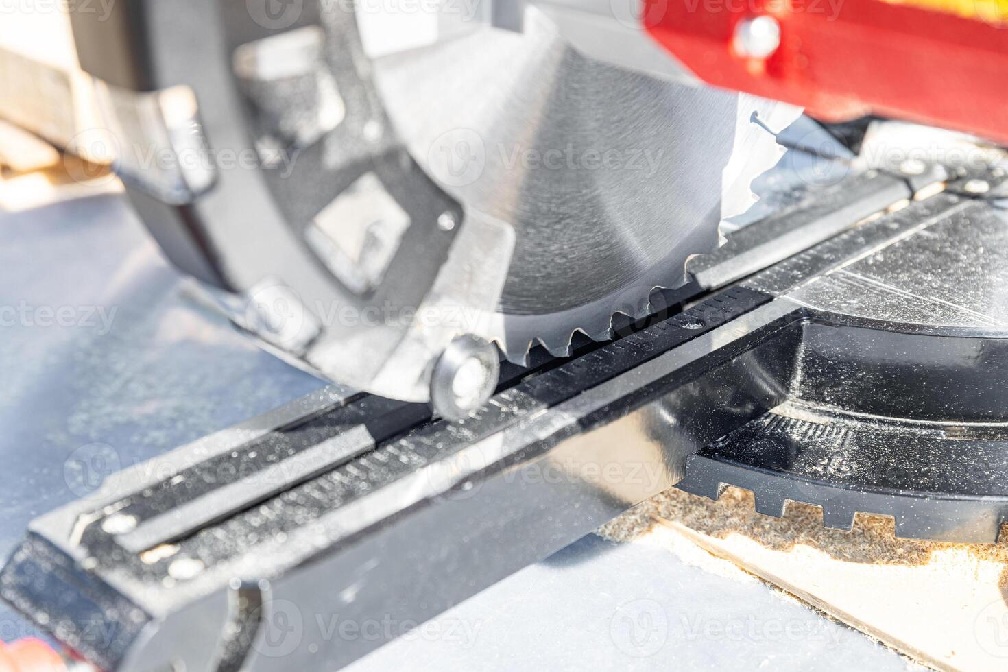 Cuts a wooden beam using a circular saw. Home furniture workshop. Work in his carpentry workshop. Miter saw and planks for building a house. photo