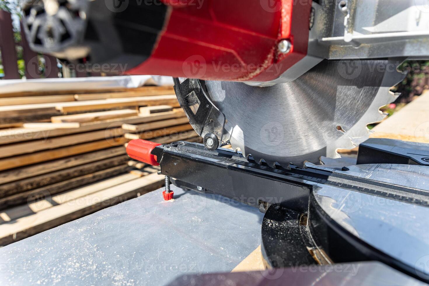 Close-up of industrial metal cutting tool. Sliding compound mitre saw or industrial saw in steel and metal production factory. Wood and sawing machine construction ideas concept. photo
