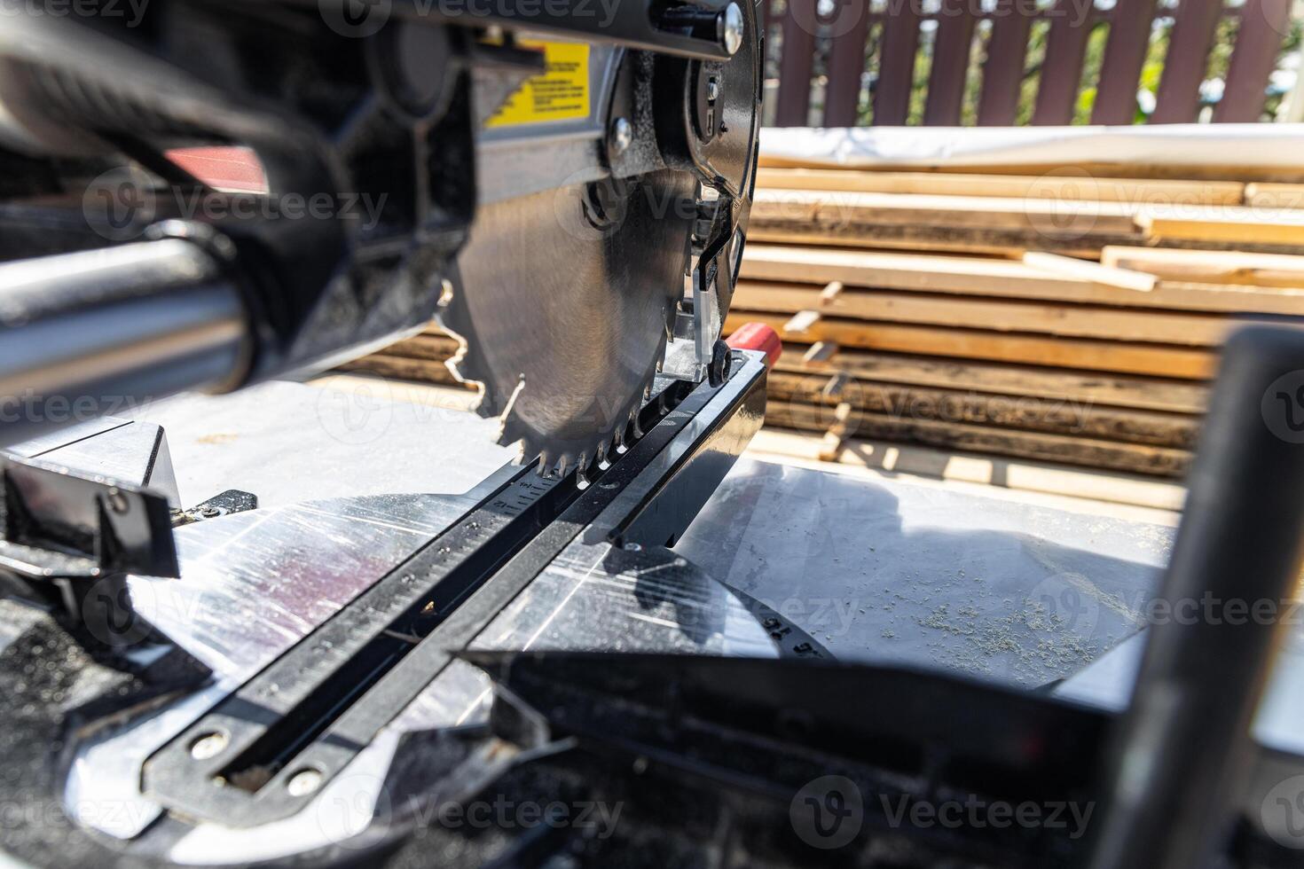 Close-up of industrial metal cutting tool. Sliding compound mitre saw or industrial saw in steel and metal production factory. Wood and sawing machine construction ideas concept. photo
