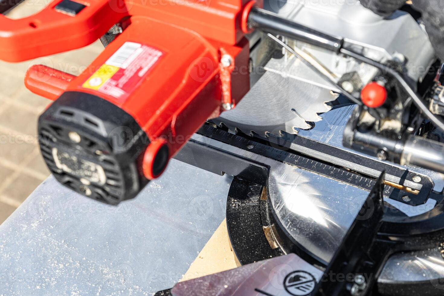 Close-up of industrial metal cutting tool. Sliding compound mitre saw or industrial saw in steel and metal production factory. Wood and sawing machine construction ideas concept. photo