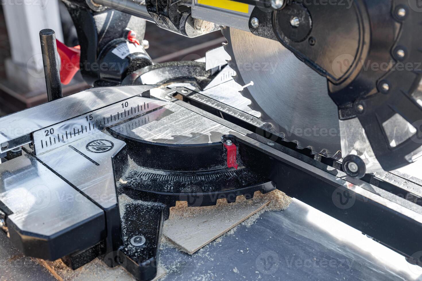 Miter saw, construction tool ,carpentry home renovation backgrounds, copy space image. Miter saw with a protective screen. Safe equipment for the furniture and construction industry. Close-up. photo