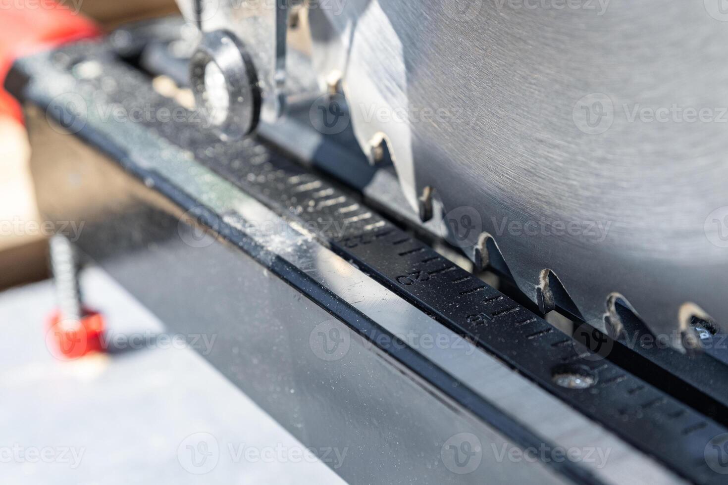 Close-up of industrial metal cutting tool. Sliding compound mitre saw or industrial saw in steel and metal production factory. Wood and sawing machine construction ideas concept. photo