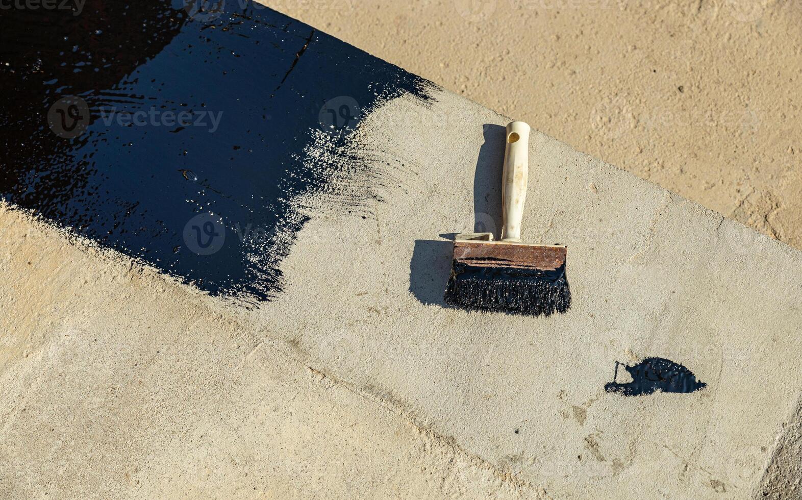 Construction techniques for waterproofing basement and foundations. Insulation material on the basement concrete wall. Waterproofing house foundation with spray on tar and roll waterproofing photo