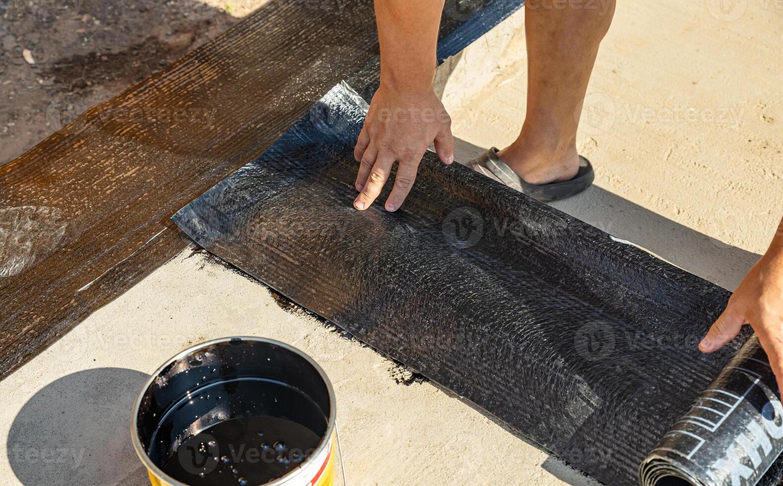 Construction techniques for waterproofing basement and foundations. Insulation material on the basement concrete wall. Waterproofing house foundation with spray on tar and roll waterproofing photo