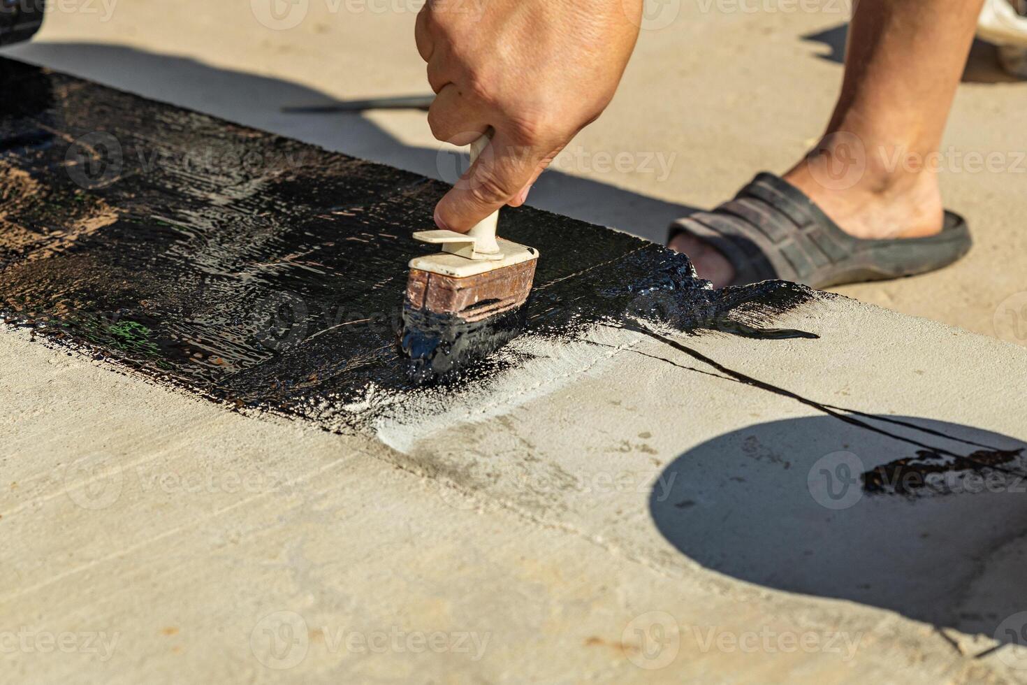 Construction techniques for waterproofing basement and foundations. Insulation material on the basement concrete wall. Waterproofing house foundation with spray on tar and roll waterproofing photo