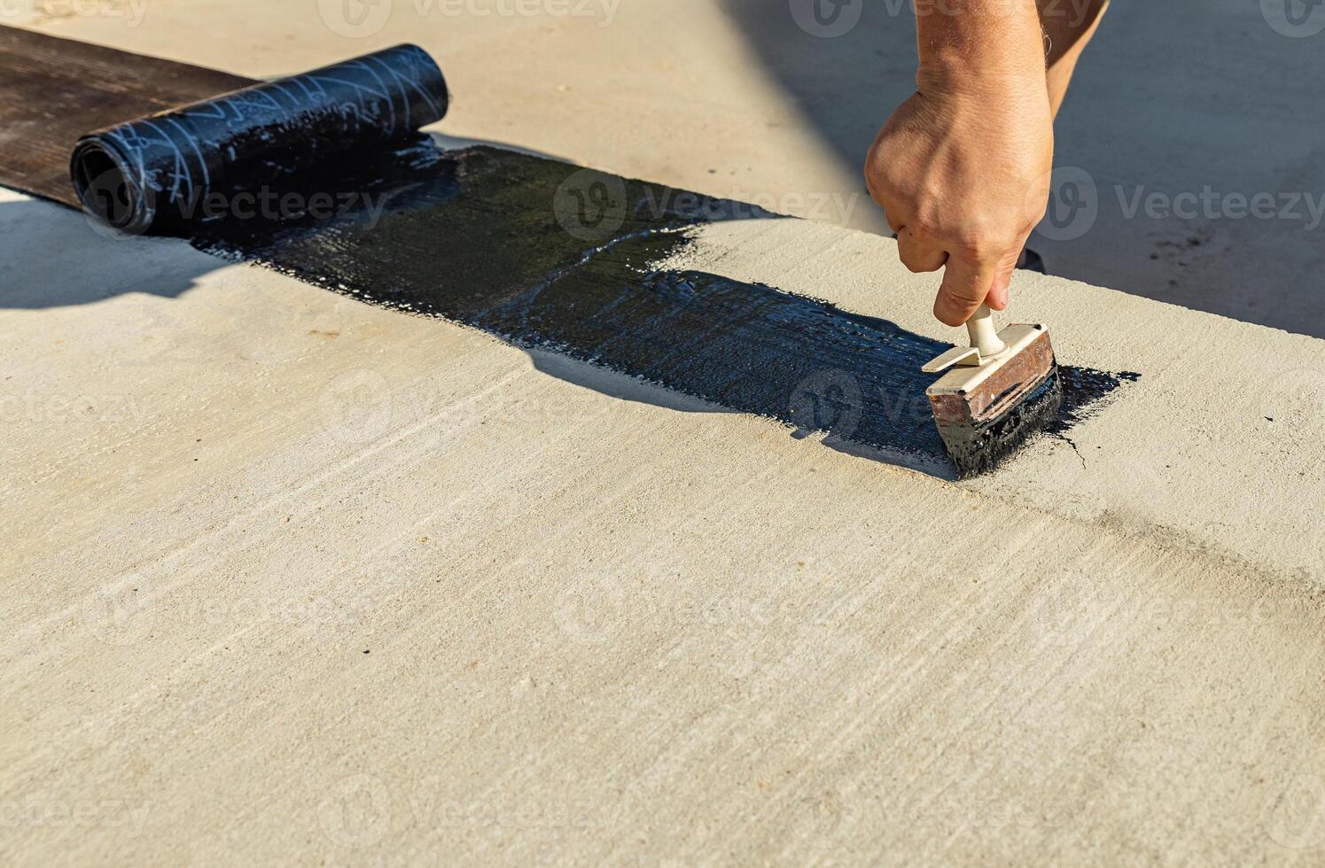 Construction techniques for waterproofing basement and foundations. Insulation material on the basement concrete wall. Waterproofing house foundation with spray on tar and roll waterproofing photo
