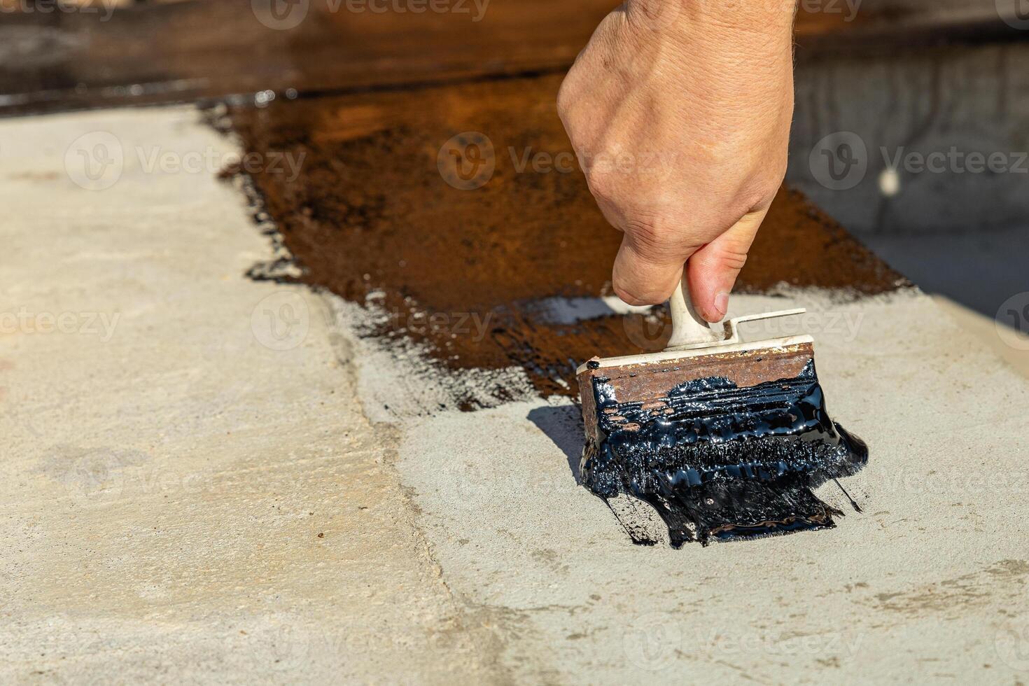 Construction techniques for waterproofing basement and foundations. Insulation material on the basement concrete wall. Waterproofing house foundation with spray on tar and roll waterproofing photo