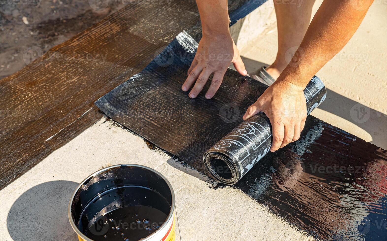 Construction techniques for waterproofing basement and foundations. Insulation material on the basement concrete wall. Waterproofing house foundation with spray on tar and roll waterproofing photo